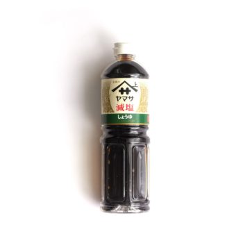 A bottle of low sodium soy sauce over a white background.